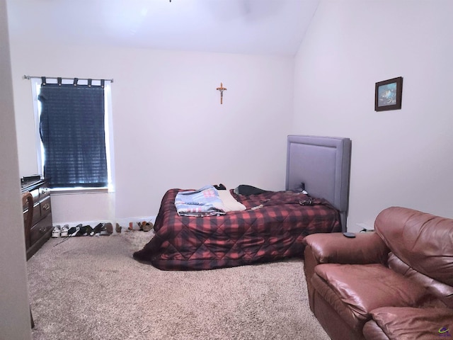 carpeted bedroom with lofted ceiling