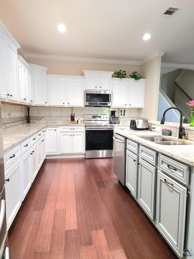 kitchen featuring white cabinets, stainless steel appliances, sink, and dark hardwood / wood-style flooring