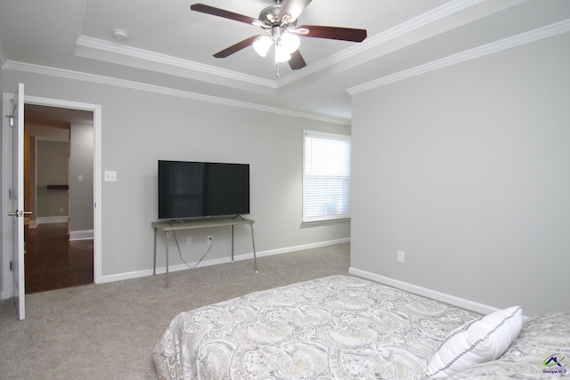 bedroom featuring crown molding, light colored carpet, a raised ceiling, and ceiling fan