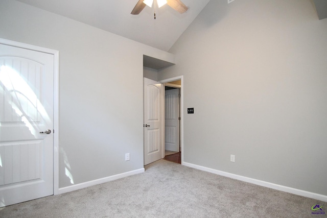 unfurnished bedroom featuring light carpet, vaulted ceiling, and ceiling fan