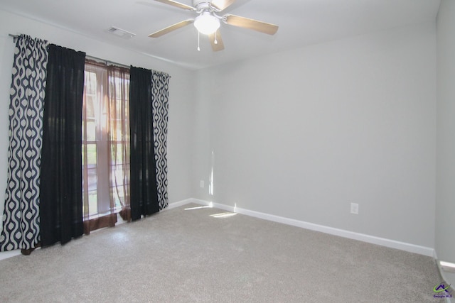 carpeted empty room featuring ceiling fan