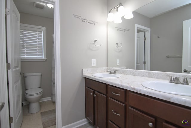 bathroom featuring vanity, toilet, and tile patterned flooring