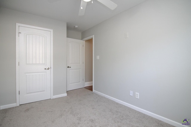 unfurnished bedroom with light carpet and ceiling fan