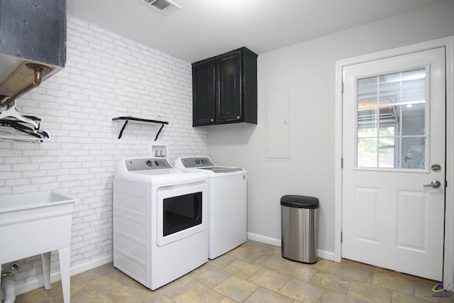 washroom with cabinets and independent washer and dryer