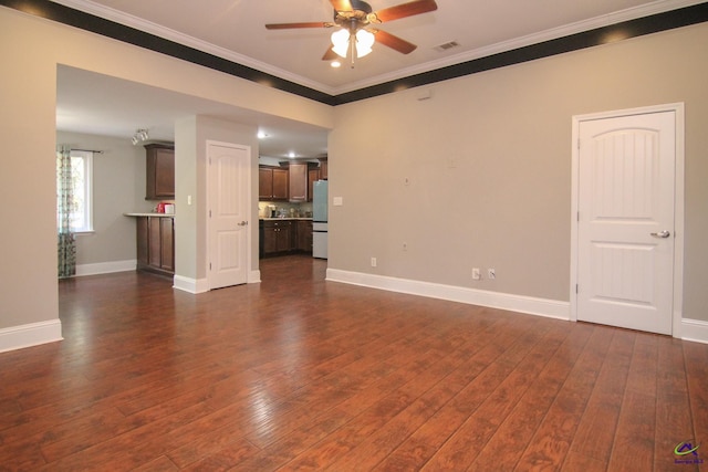 unfurnished living room featuring ceiling fan, ornamental molding, and dark hardwood / wood-style floors