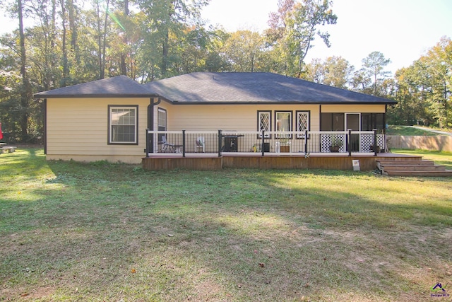 view of front of house featuring a wooden deck and a front lawn