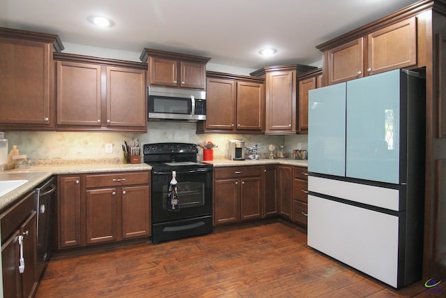 kitchen featuring decorative backsplash, black appliances, and dark hardwood / wood-style floors