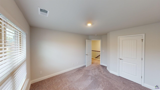 empty room with light colored carpet