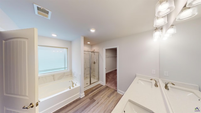 bathroom featuring vanity, separate shower and tub, and hardwood / wood-style floors