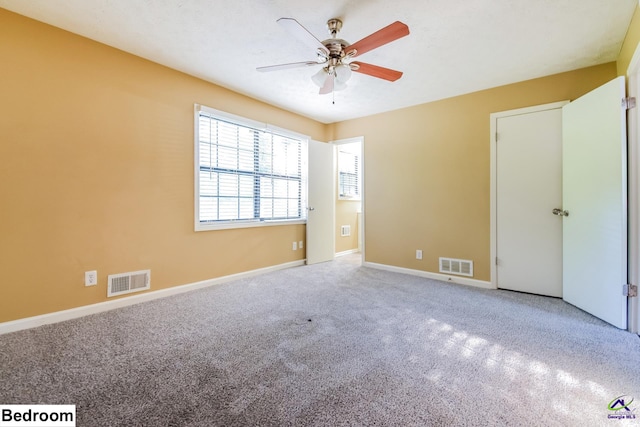 unfurnished bedroom with carpet floors and ceiling fan