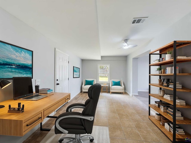 tiled office space with ceiling fan