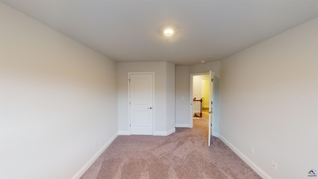 unfurnished bedroom featuring light colored carpet