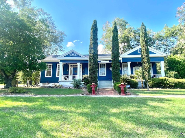 neoclassical / greek revival house featuring a porch and a front lawn