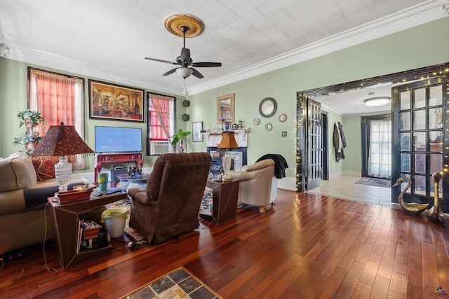 living room with wood-type flooring, cooling unit, crown molding, and ceiling fan