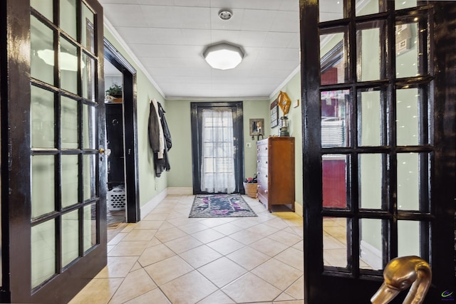 entrance foyer featuring crown molding, light tile patterned floors, and french doors