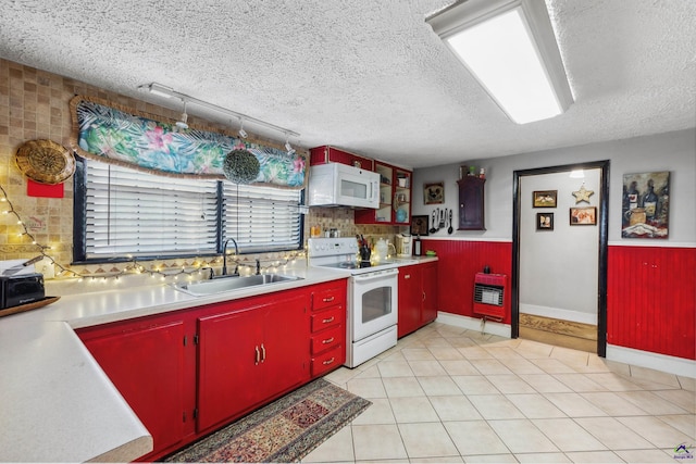 kitchen featuring a textured ceiling, sink, white appliances, and rail lighting