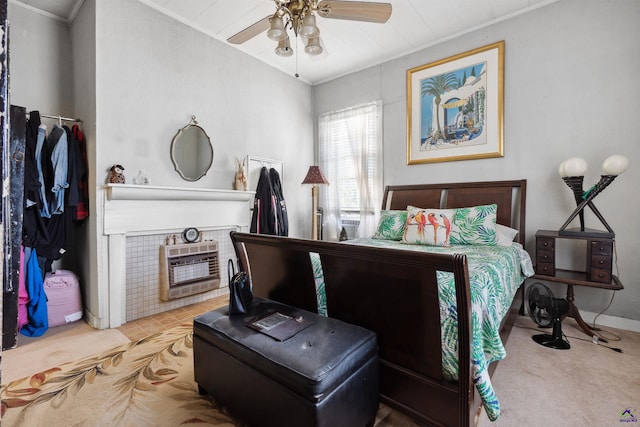 bedroom with ornamental molding, heating unit, ceiling fan, and carpet flooring