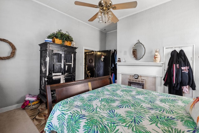 carpeted bedroom featuring crown molding, a fireplace, and ceiling fan