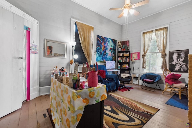 living room with ceiling fan and hardwood / wood-style floors