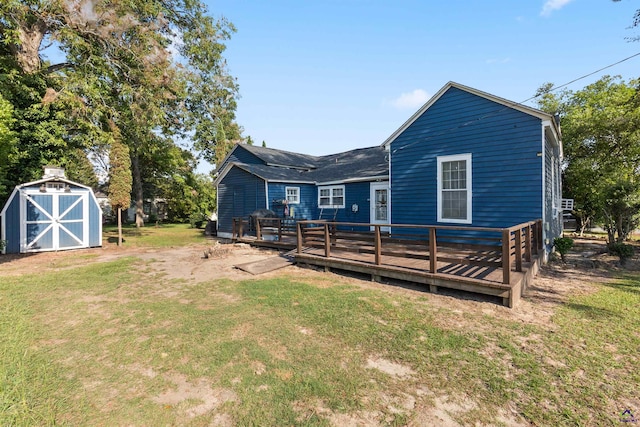 rear view of property with a lawn, a shed, and a deck