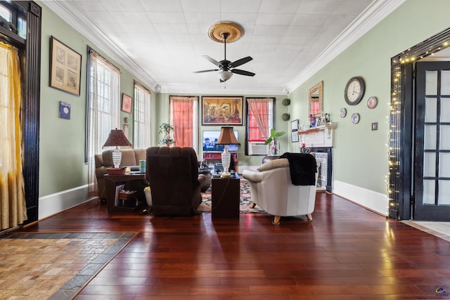 living room with ornamental molding, ceiling fan, and dark wood-type flooring