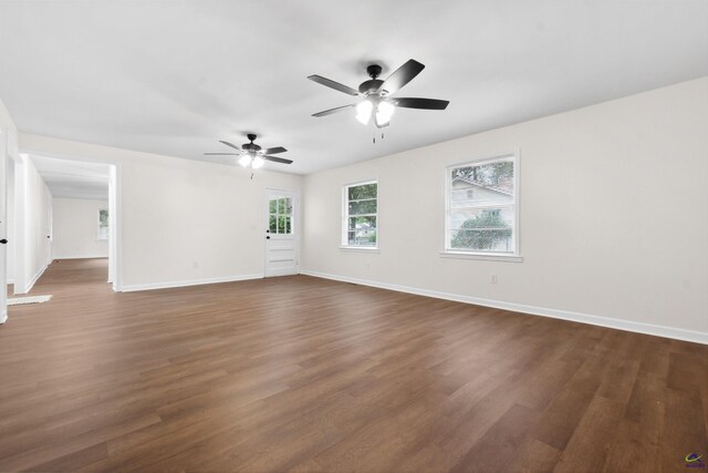 unfurnished room featuring ceiling fan and dark wood-type flooring