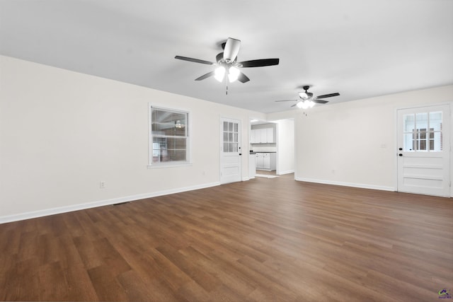 unfurnished living room with ceiling fan and dark hardwood / wood-style flooring