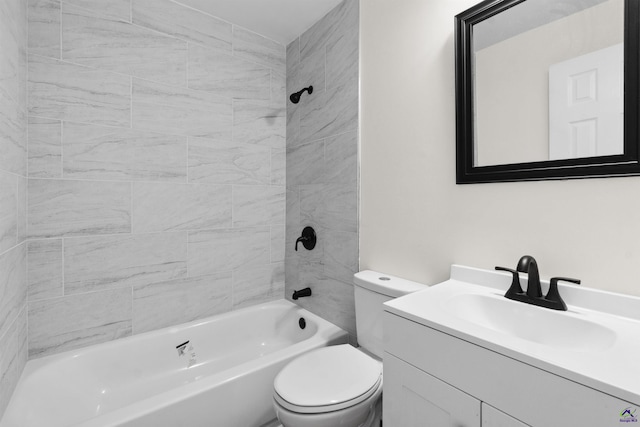 full bathroom featuring tiled shower / bath, vanity, and toilet