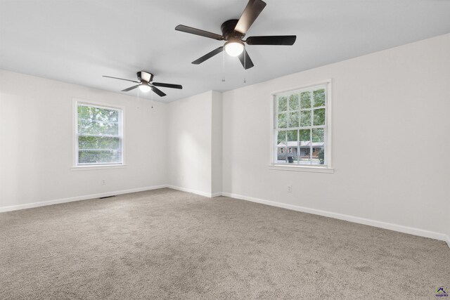 unfurnished room with ceiling fan and carpet flooring