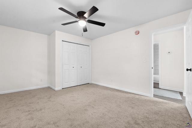 unfurnished bedroom featuring a closet, ceiling fan, and light colored carpet