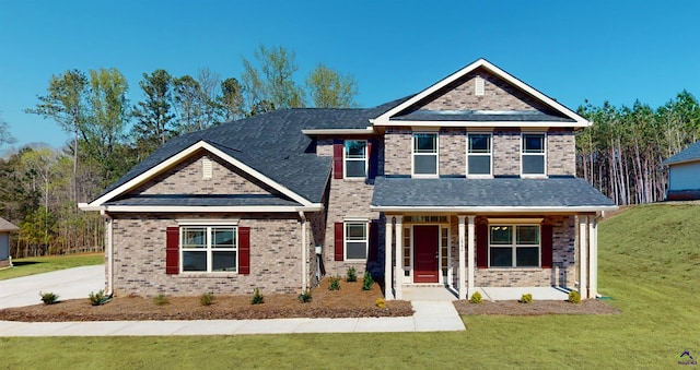 craftsman house with a porch and a front yard