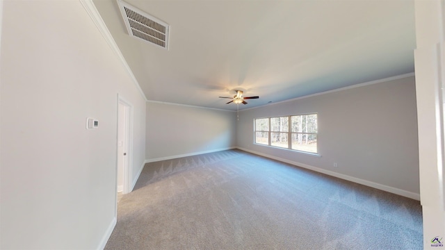 empty room with ceiling fan, light colored carpet, and crown molding