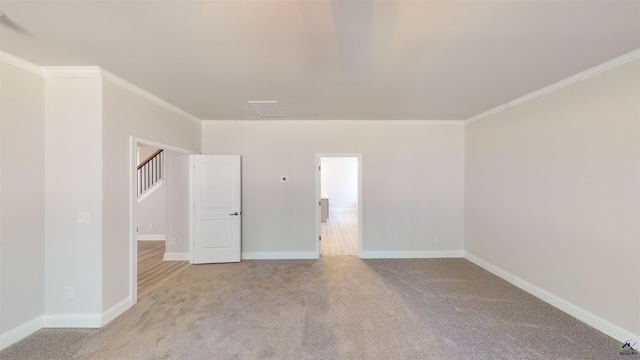 spare room with light carpet and ornamental molding