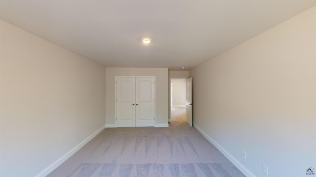 empty room featuring light carpet