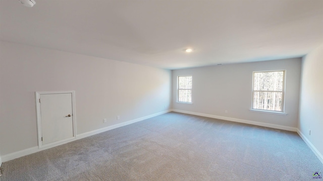 unfurnished room featuring light colored carpet