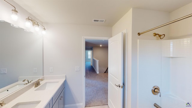 bathroom with a shower and vanity