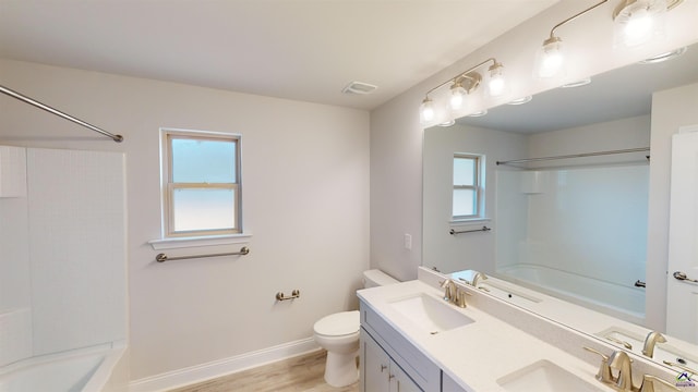 full bathroom with vanity, bathing tub / shower combination, toilet, and hardwood / wood-style flooring