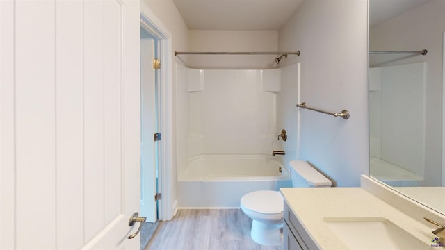 full bathroom featuring vanity, shower / bathtub combination, hardwood / wood-style floors, and toilet