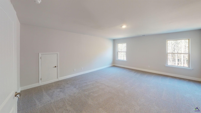 unfurnished room featuring carpet