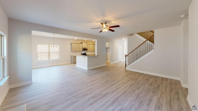 unfurnished living room with ceiling fan and light hardwood / wood-style flooring