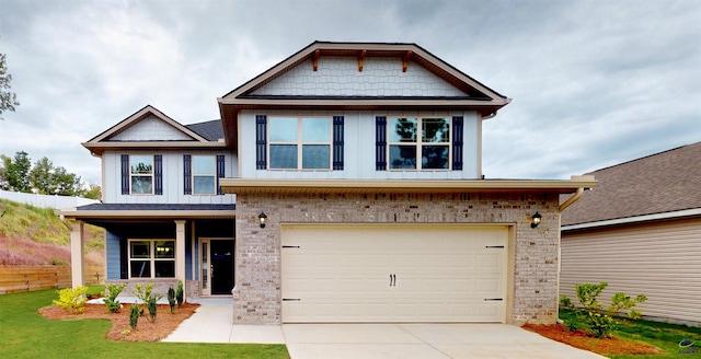 craftsman-style home with driveway, board and batten siding, a front yard, brick siding, and a garage