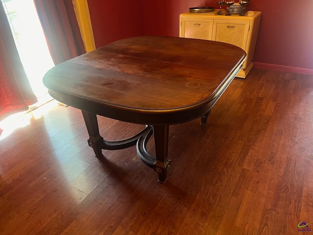 dining space with dark hardwood / wood-style flooring