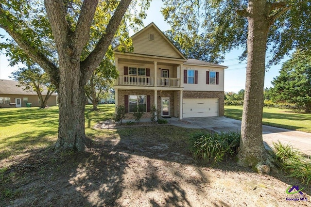 view of front of home featuring a balcony, a front yard, and a garage