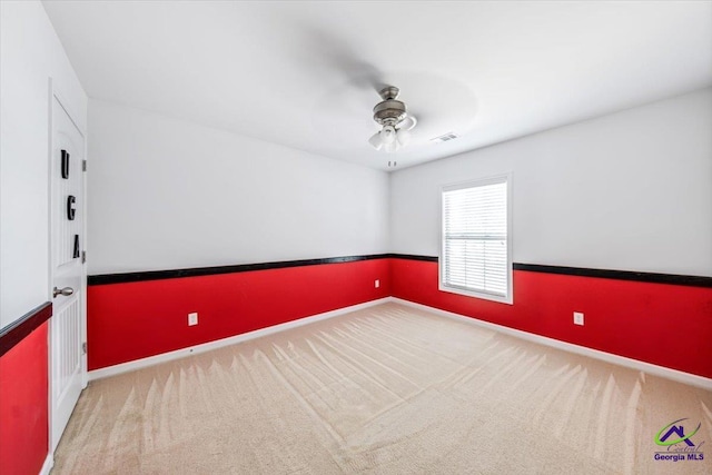 empty room with ceiling fan and carpet flooring