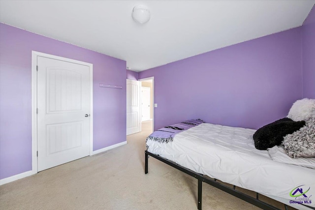 bedroom featuring light colored carpet