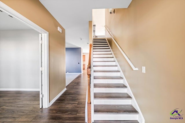 staircase featuring wood-type flooring