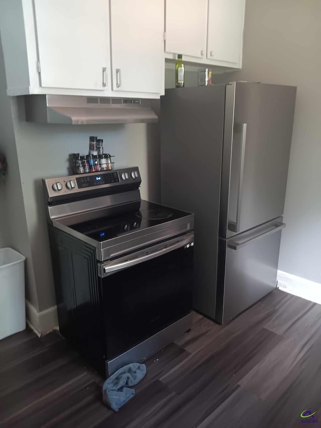 kitchen with white cabinetry, dark wood-type flooring, stainless steel fridge, electric stove, and exhaust hood