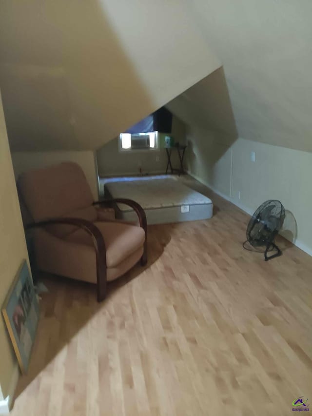 interior space with vaulted ceiling and light wood-type flooring