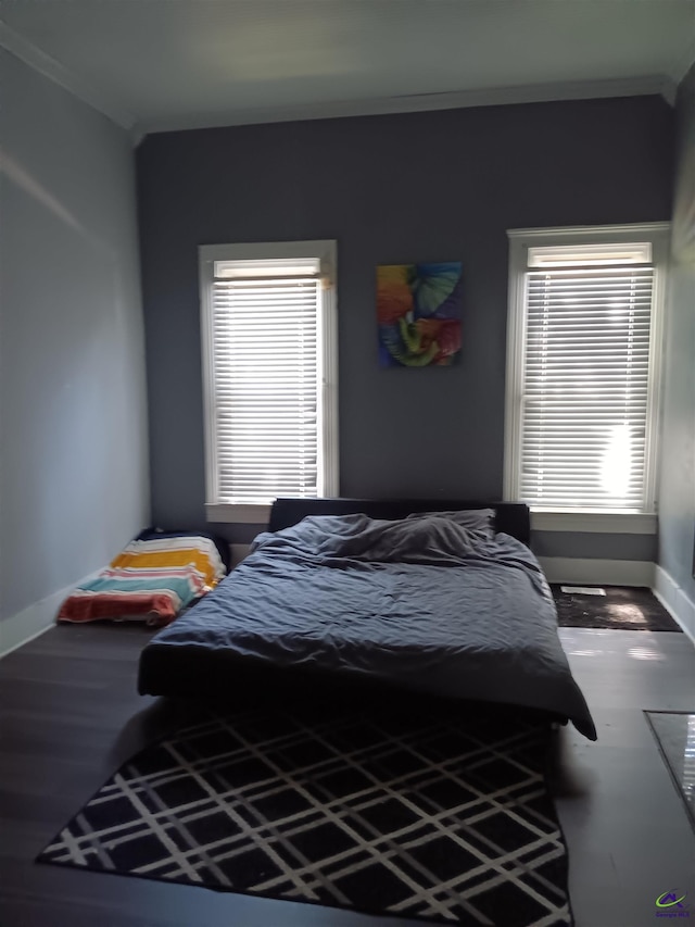 bedroom with ornamental molding and multiple windows