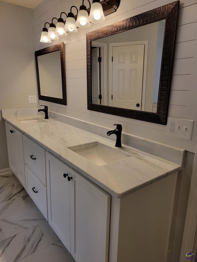 full bathroom featuring a sink, double vanity, and marble finish floor